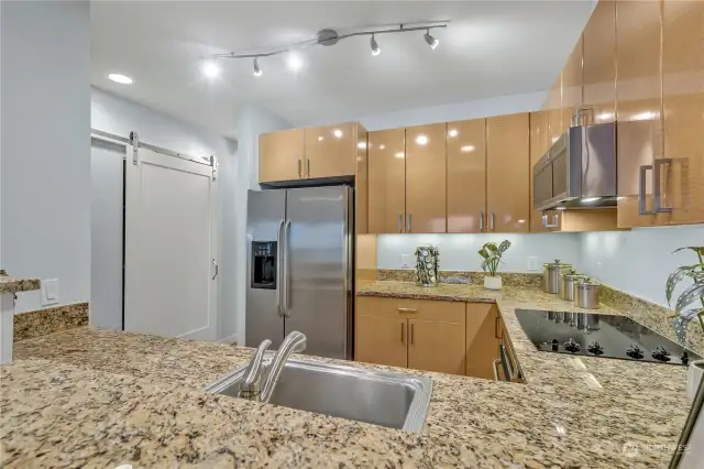 From the breakfast bar, you can see the pantry behind the sliding barn door.