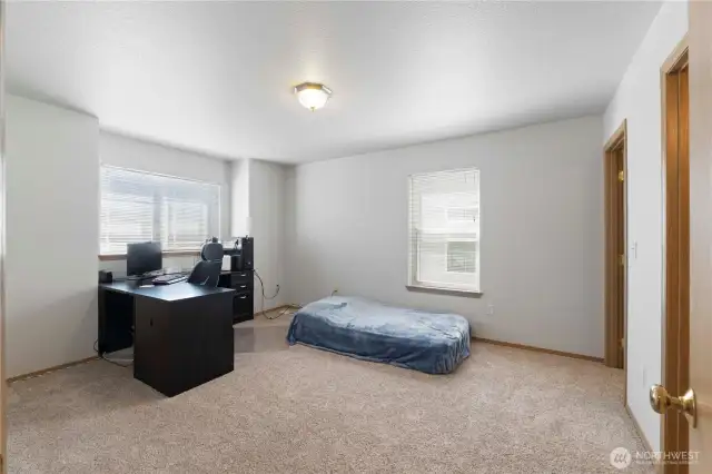 The primary suite is huge and could easily fit a king sized bed. The owners gave it to their son who needs more space for gaming.