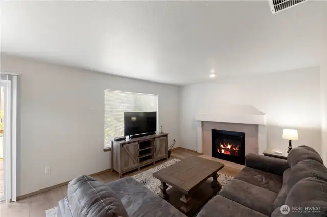 The large family room is just off the kitchen and includes a gas fireplace.