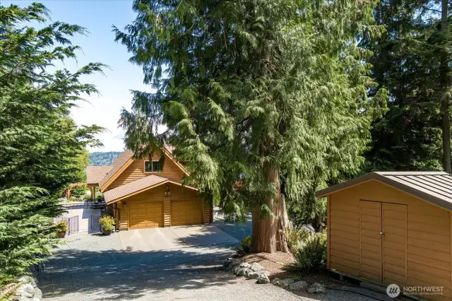 Driveway into two car garage with RV parking space to the right of garage. Garden shed for mower, etc.