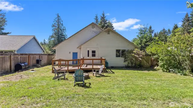 From the fruit trees looking toward the deck with ramp, convenient door from deck to the second BR.