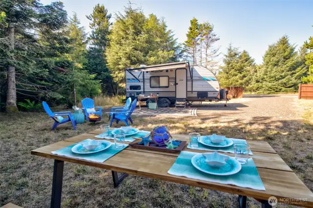 A peaceful setting awaits—surrounded by trees and fenced for privacy, with water, sewer, and electric on-site. Settle in on the clean, gravel-packed pad.