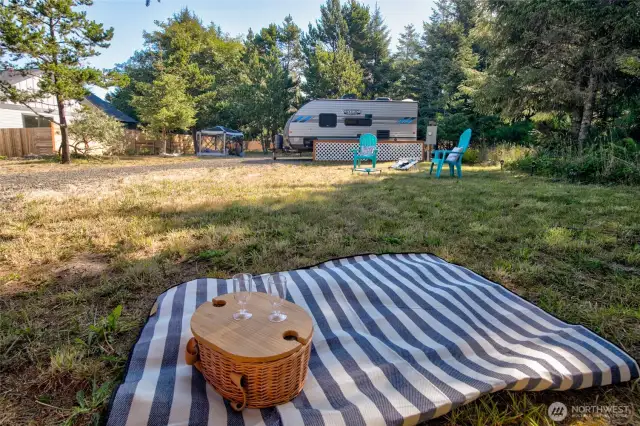 Nestled among the trees and bordered by a privacy fence, this lot provides full utilities and a solid gravel surface—perfect for setting up your RV or camper.