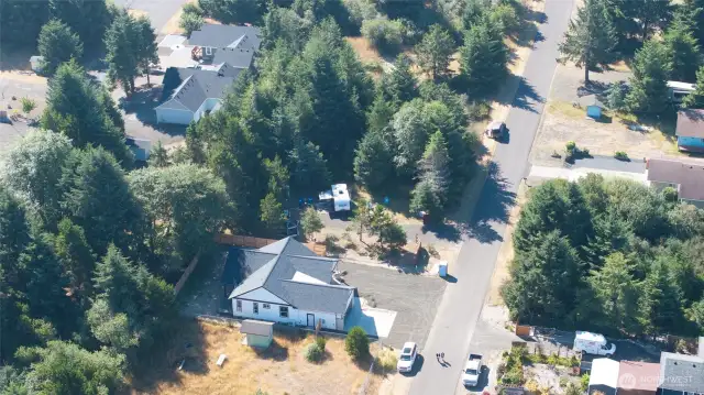 Private and practical—this lot offers a gravel base, full utility hookups, fencing, and lush trees to enhance your camping experience.