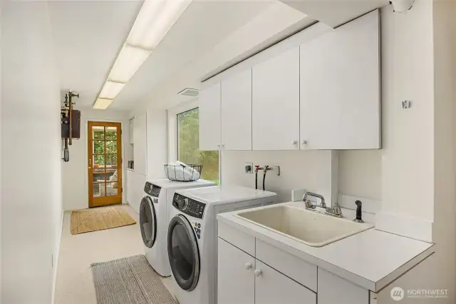 Large Laundry room with storage and sink.