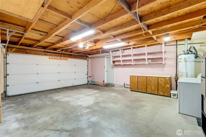 Two car garage with water heater and laundry area