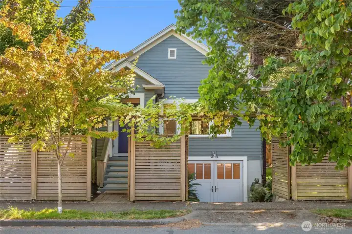 Well sited among mature landscaping with a custom cedar privacy fence.