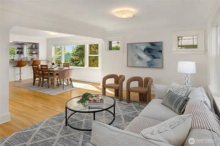 Living to dining room flow--arch opening and leaded windows retain the home's 1927 character, breakfast bar beyond.