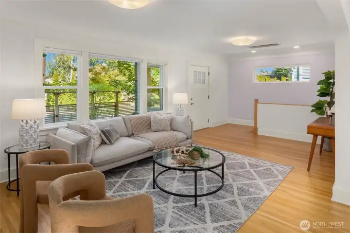 Upon entry to the home, greeted by original coved ceilings, oak floors and ample windows for natural light and leafy outlooks.