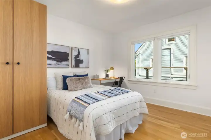 One of two upper level bedrooms with built-ins.