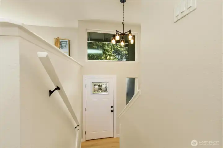 The entrance is grand with tall ceilings and a ton of natural light.