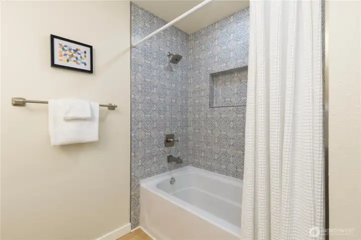 There is a tub/shower combo in this upstairs bathroom.