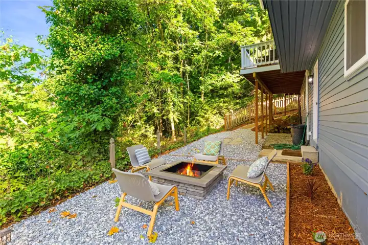 The low maintenance back yard has a built-in fire pit for your enjoyment. It's so tranquil here - it feels like you're camping!