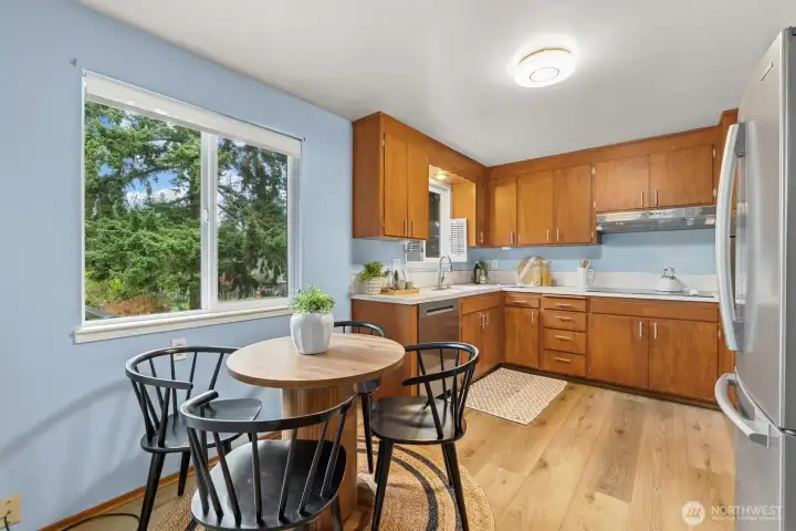 Spacious kitchen, complete with eating area, new vinyl plank floors, new dishwasher and new oven