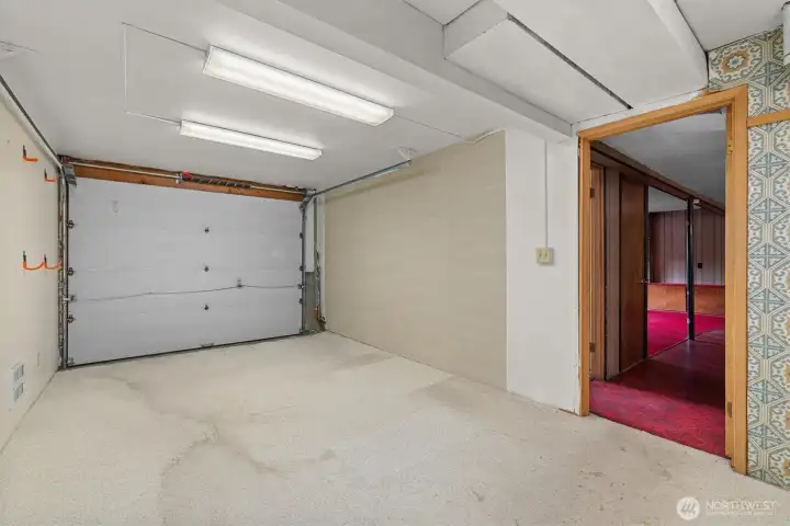 This garage bay would be a perfect home gym, additional storage or easily converted back to a garage for your vehicle.  Door is fully functional