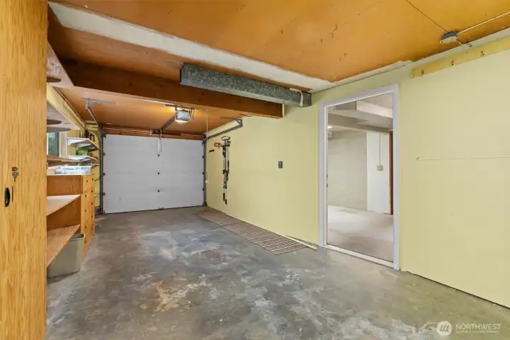 Second garage bay complete with additional shelving and storage