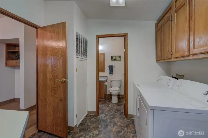 Laundry room that adjoins full bathroom.