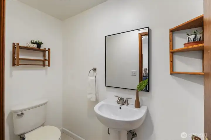 Updated half bath with new sink, mirror, and paint.