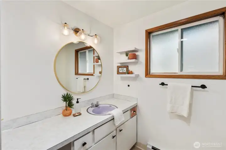 Full bathroom with a lot  of counter space and a linen closet.