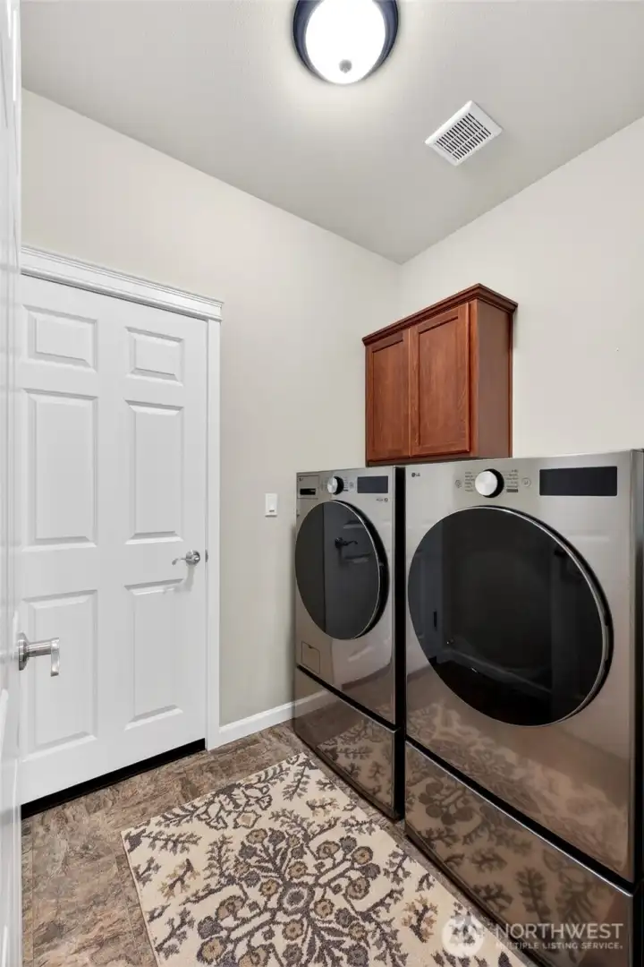 Laundry room just off of the hall with a door to the garage. W/D go with the sellers.