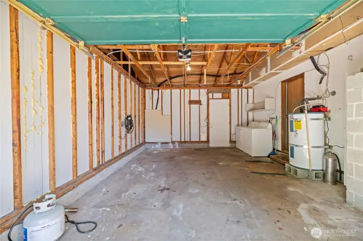 Long garage with room for 1 car, storage, and W/D