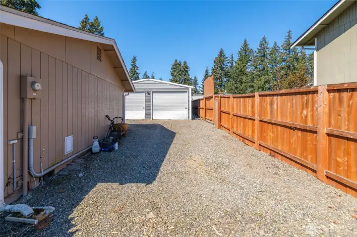 Entry to garage past a double-gated fence