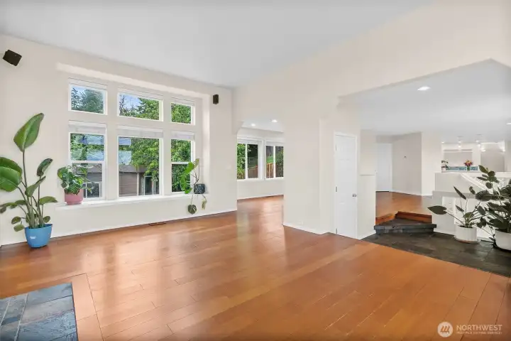 Gas fireplace with tile surround, hardwood floors, and a bright, open living space.