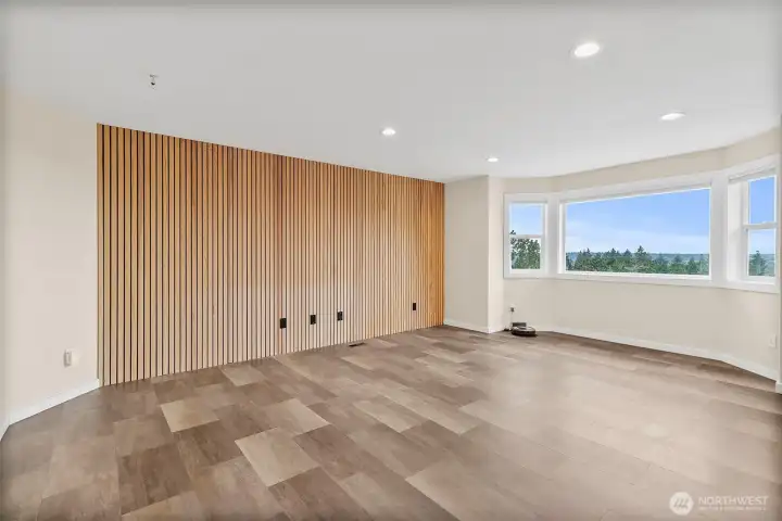Living room with a designer slat wall, large view windows, and bright open space.