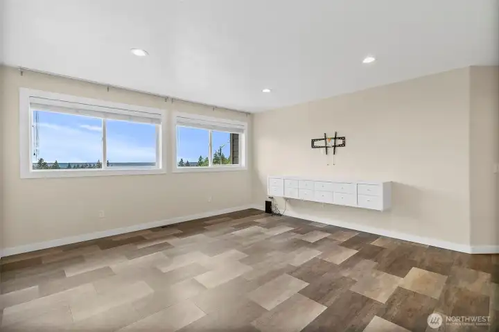 Primary bedroom with large windows, mountain views, and built-in wall storage for a clean, open feel.