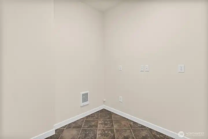 Studio closet and storage area with tile flooring and extra space for belongings.