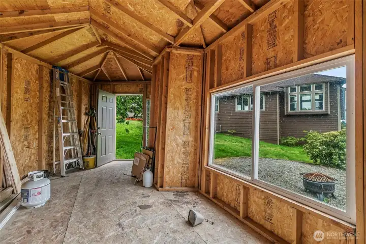 Large storage shed with window, high ceiling, and plenty of room for tools, yard gear, or extra storage.