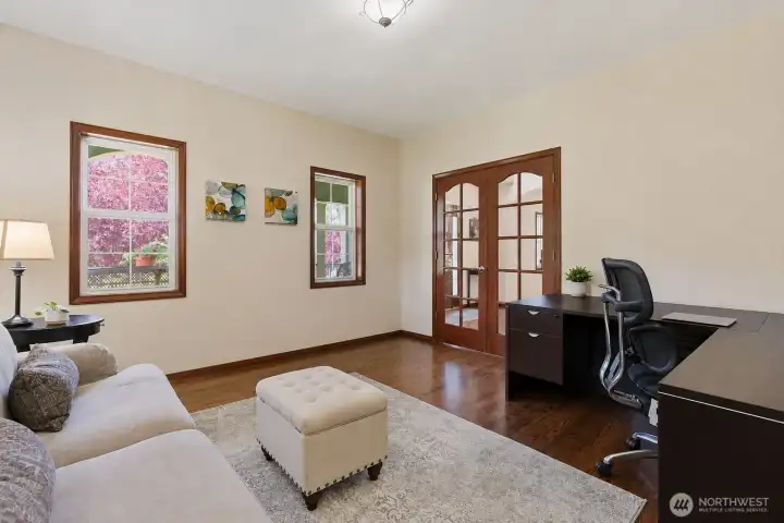 The spacious dedicated office offers the perfect work-from-home setup with French doors, abundant natural light, and plenty of room for executive workspace or creative pursuits