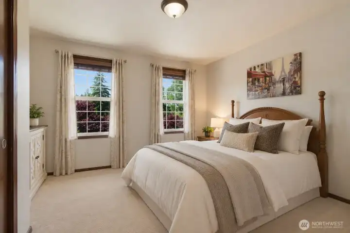 One of four spacious bedrooms, this inviting room features two large windows and generous space for everyday comfort