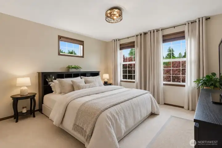 Generously sized and filled with natural light from dual large windows, this additional bedroom offers comfort, flexibility, and beautiful outdoor views