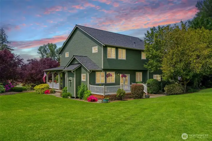 Set on 1.05 beautifully landscaped acres, the property offers expansive lawn space, dual wraparound decks, and a stunning park-like setting rarely found this close to town