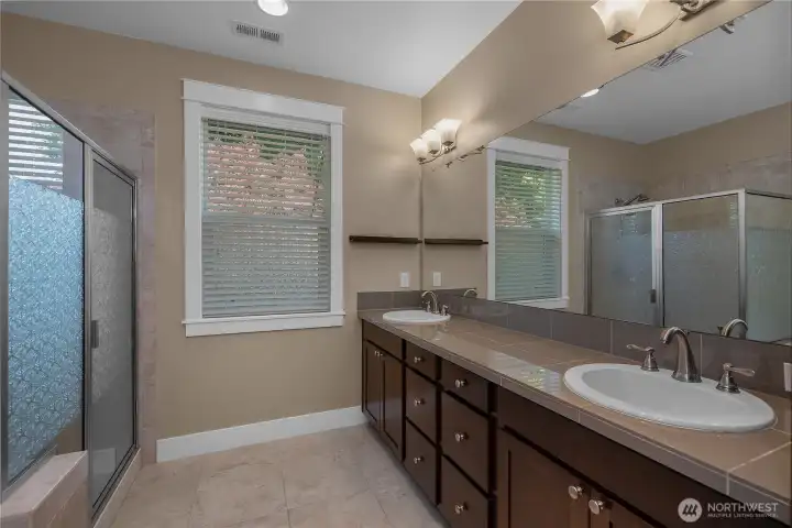 PBR en suite - Extended dual-sink vanity offers generous cabinetry, counter space, a full-width mirror and adjacent shower. PBR en suite - Extended dual-sink vanity offers generous cabinetry, counter space, a full-width mirror and adjacent shower.