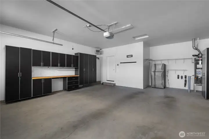 Finished 2-car garage with extensive custom cabinetry, workbench, overhead storage, heater and utility area. Finished 2-car garage with extensive custom cabinetry, workbench, overhead storage, heater and utility area.