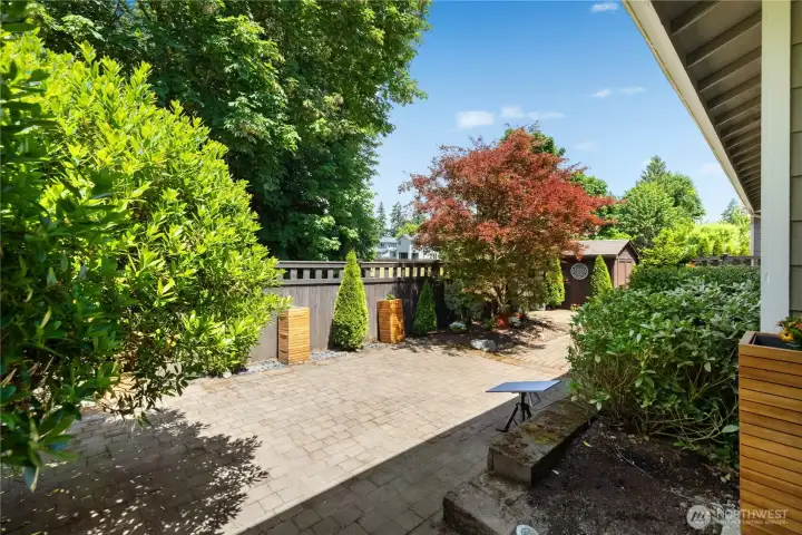 Expansive paver patio surrounded by mature landscaping, privacy fencing and colorful ornamental trees. Expansive paver patio surrounded by mature landscaping, privacy fencing and colorful ornamental trees.