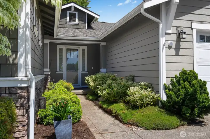 Private covered entry with decorative glass door, sidelights and attractive architectural detailing. Private covered entry with decorative glass door, sidelights and attractive architectural detailing.