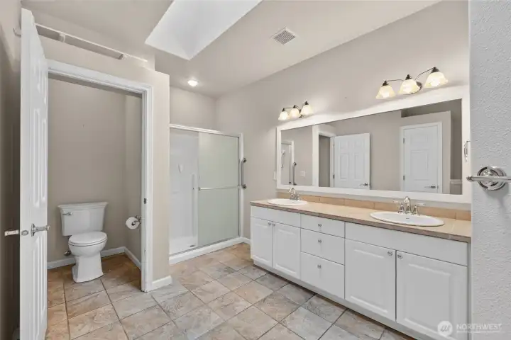primary bath featuring a large walk in shower primary bath featuring a large walk in shower