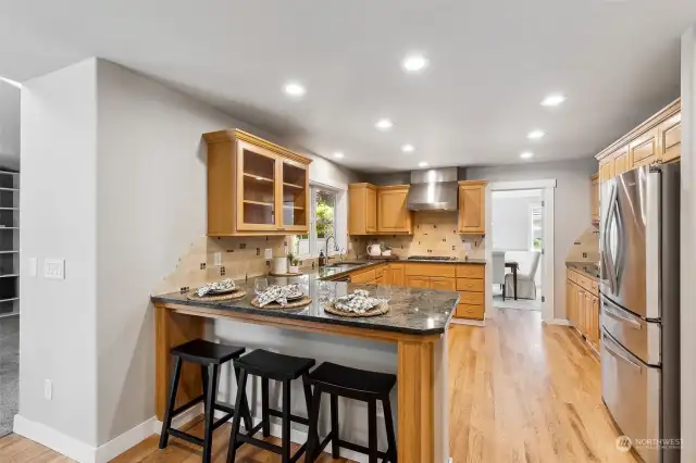 Kitchen incudes wolf cooktop, wall oven/microwave, granite counters and bar seating too!