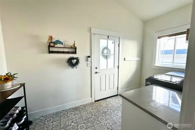 Door off mudroom/laundry leads to back porch and garage.