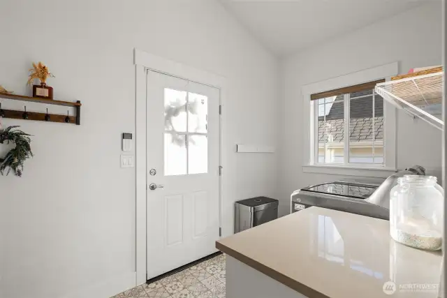 Backdoor leads to back porch and garage, through convenient, bright laundry