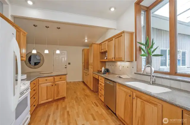 This kitchen is a show stopper!  Sink overlooks large windows offering natural light but also private.