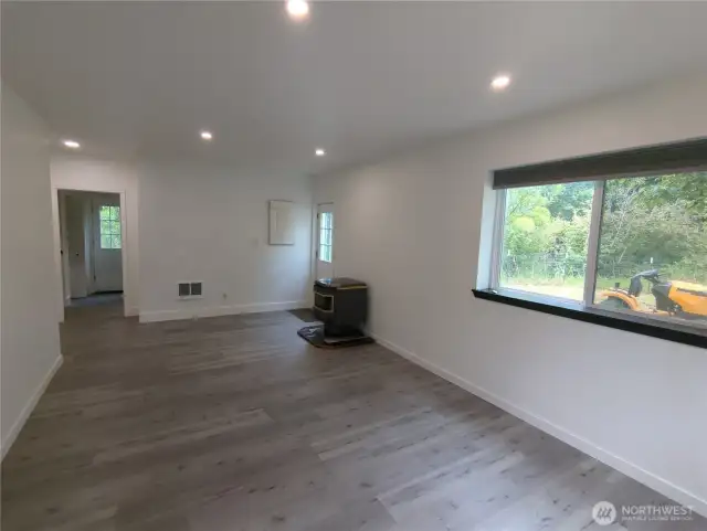 Stepping in thru the front door into the living room.  Cozy with the pellet stove that will heat the whole home.