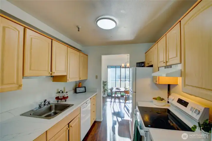 Spacious kitchen with beautiful cabinetry, hardwood floors, and quartz countertops