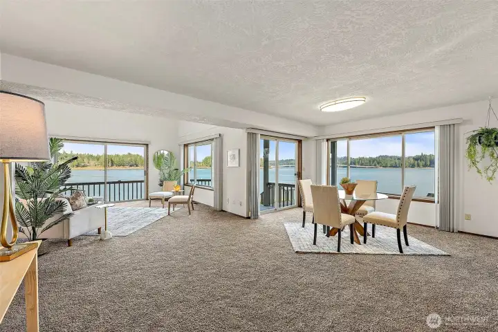 Open great room design combining living and dining spaces, oriented to capture sweeping Sound and bridge views.