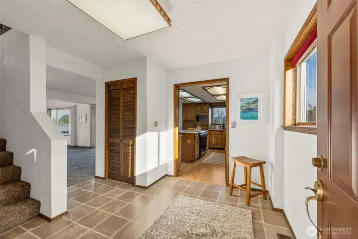 Inviting entry leads into a home that lives like a rambler, with primary bedroom on the main level.