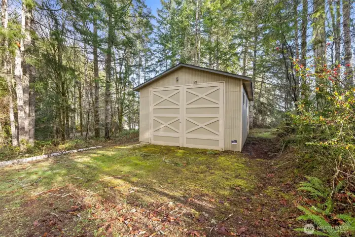 Spacious 556 sq ft detached garage with high ceilings and wide barn doors ideal for RV, boat, or multi-vehicle use.