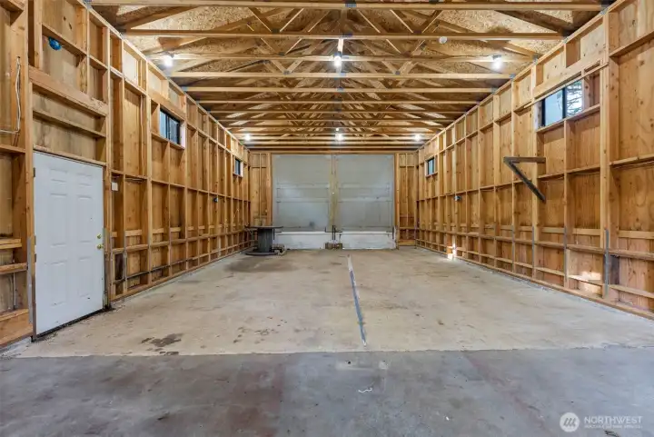 556 sq ft detached garage designed with high ceilings and oversized barn doors for flexible vehicle use.